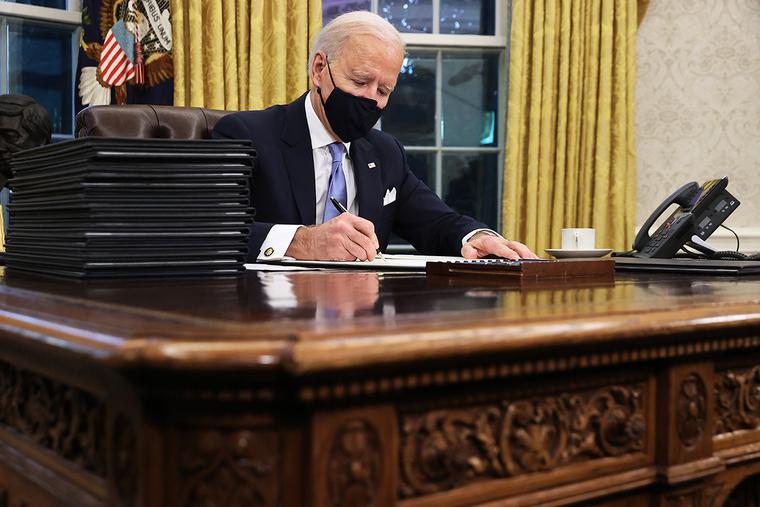 U.S. President Joe Biden prepares to sign a series of executive orders at the Resolute Desk in the Oval Office just hours after his inauguration today in Washington, D.C. U.S. President Joe Biden prepares to sign a series of executive orders at the Resolute Desk in the Oval Office just hours after his inauguration today in Washington, D.C.