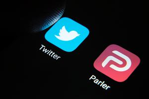 Parler and Twitter apps shown on smartphone. Parler and Twitter apps shown on smartphone.