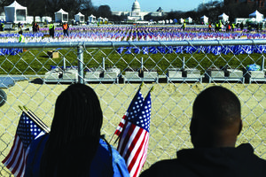 People collect flags that decorated the National Mall in Washington on Jan. 21, one day after the inauguration of U.S. President Joe Biden. The Presidential Inaugural Committee encouraged supporters to sponsor the flags through donations to 95 groups, including the Planned Parenthood Federation of America. People collect flags that decorated the National Mall in Washington on Jan. 21, one day after the inauguration of U.S. President Joe Biden. The Presidential Inaugural Committee encouraged supporters to sponsor the flags through donations to 95 groups, including the Planned Parenthood Federation of America.