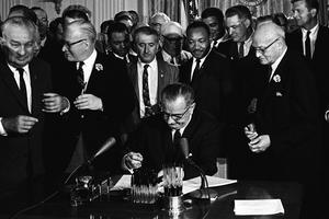 With Dr. Martin Luther King, Jr., looking on, President Lyndon B. Johnson signs into law the Civil Rights Act on July 2, 1964. With Dr. Martin Luther King, Jr., looking on, President Lyndon B. Johnson signs into law the Civil Rights Act on July 2, 1964.