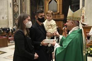 A Roma soccer player Lorenzo Pellegrini and his family receive a Bible from Archbishop Rino Fisichella, in St. Peter's Basilica Jan. 24, 2021. A Roma soccer player Lorenzo Pellegrini and his family receive a Bible from Archbishop Rino Fisichella, in St. Peter's Basilica Jan. 24, 2021.