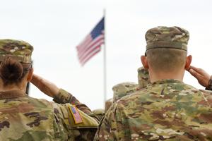 American soldiers salute the American flag. American soldiers salute the American flag.