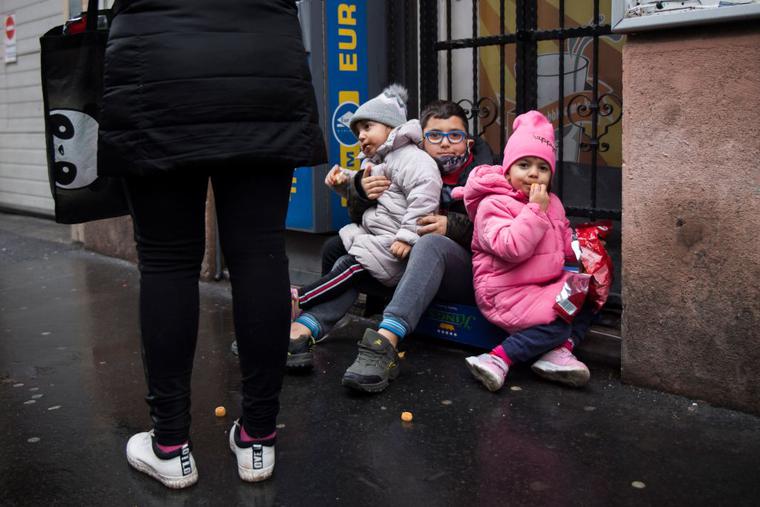 Children look on as people queue for food packages distributed by restaurant owner Norbert Bango (not pictured) in downtown Budapest on December 30, 2020. Hungarian families stricken by unemployment due to the Covid crisis who have fallen through the country's flimsy social security net have had to turn to a pop-up privately-run soup kitchen for help. Children look on as people queue for food packages distributed by restaurant owner Norbert Bango (not pictured) in downtown Budapest on December 30, 2020. Hungarian families stricken by unemployment due to the Covid crisis who have fallen through the country's flimsy social security net have had to turn to a pop-up privately-run soup kitchen for help.