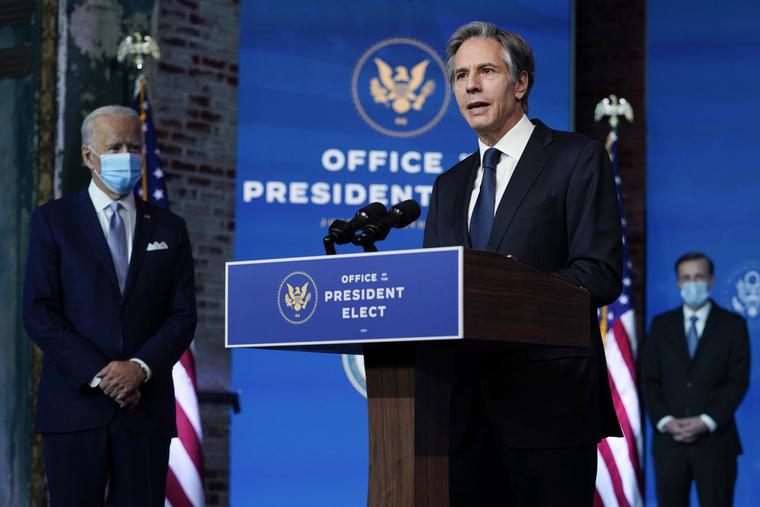 Secretary of State Antony Blinken with President-elect Joe Biden in the background. Secretary of State Antony Blinken with President-elect Joe Biden in the background.