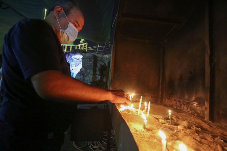 A worshipper lights a candle at the Chaldean Catholic Church of St. Joseph in the Iraqi capital Baghdad, on November 7, 2020. A few hundred thousand Christians are left in Iraq. A worshipper lights a candle at the Chaldean Catholic Church of St. Joseph in the Iraqi capital Baghdad, on November 7, 2020. A few hundred thousand Christians are left in Iraq.
