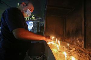 A worshipper lights a candle at the Chaldean Catholic Church of St. Joseph in the Iraqi capital Baghdad, on November 7, 2020. A few hundred thousand Christians are left in Iraq. A worshipper lights a candle at the Chaldean Catholic Church of St. Joseph in the Iraqi capital Baghdad, on November 7, 2020. A few hundred thousand Christians are left in Iraq.