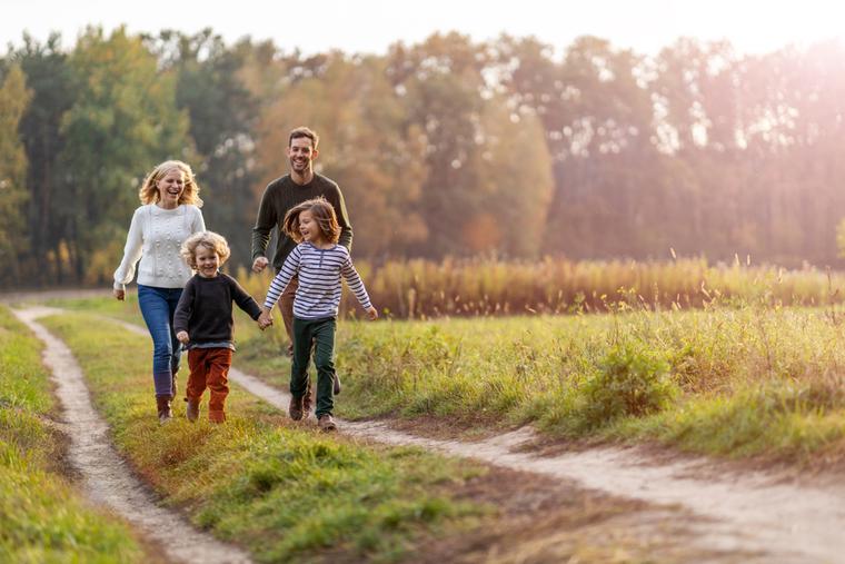 Young family taking a walk outdoors. Young family taking a walk outdoors.