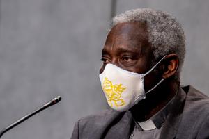 Cardinal Peter Turkson, prefect of the Dicastery for Promoting Integral Human Development, shown wearing a mask during a news conference on July 7, 2020, says the Vatican is committed to participating in dialogue about economic matters that impact the worldwide common good. Cardinal Peter Turkson, prefect of the Dicastery for Promoting Integral Human Development, shown wearing a mask during a news conference on July 7, 2020, says the Vatican is committed to participating in dialogue about economic matters that impact the worldwide common good.