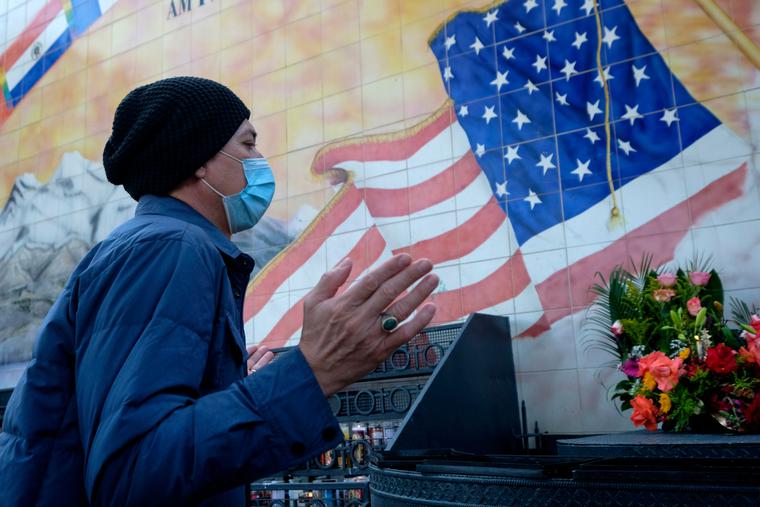 A man wearing a face mask prays in front of a mural outside Our Lady of Guadalupe Chapel in Los Angeles, Thursday, Nov. 26, 2020. A man wearing a face mask prays in front of a mural outside Our Lady of Guadalupe Chapel in Los Angeles, Thursday, Nov. 26, 2020.