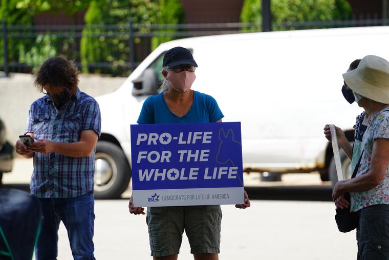 Pro-lifers hold a Democrats for Life sign in Milwaukee, Wisc. Pro-lifers hold a Democrats for Life sign in Milwaukee, Wisc.