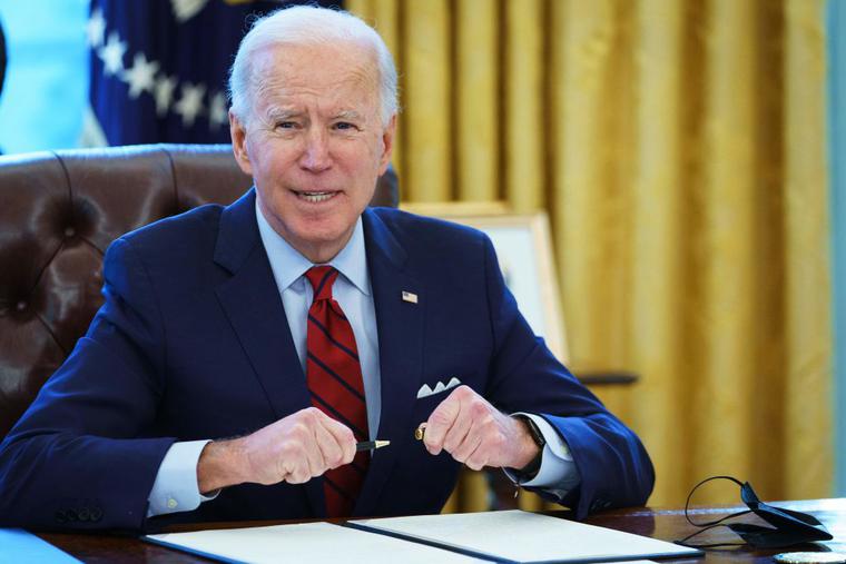 US President Joe Biden prepares to sign executive orders in the Oval Office of the White House in Washington, DC, on January 28, 2021. US President Joe Biden prepares to sign executive orders in the Oval Office of the White House in Washington, DC, on January 28, 2021.
