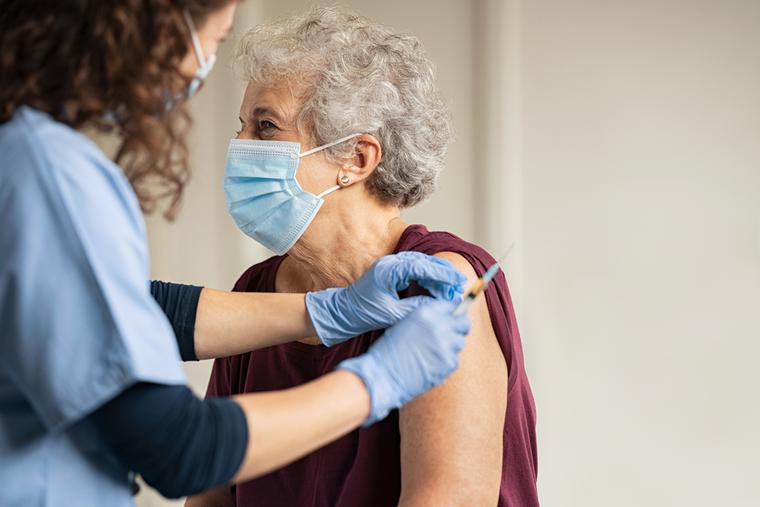 An elderly patient receives the COVID vaccine. An elderly patient receives the COVID vaccine.
