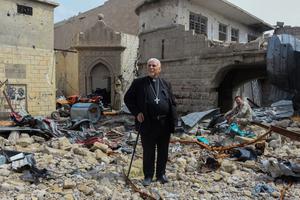 Father John Botros Moshi, the Syriac Catholic Archbishop of Mosul, Kirkuk, and the Kurdistan Region, stands in the rubbles of the Tahra church in Mosul on April 29, 2018. - The church, established during the seventh century, was destroyed by bombings when the regime was fighting jihadists in this area. Father John Botros Moshi, the Syriac Catholic Archbishop of Mosul, Kirkuk, and the Kurdistan Region, stands in the rubbles of the Tahra church in Mosul on April 29, 2018. - The church, established during the seventh century, was destroyed by bombings when the regime was fighting jihadists in this area.