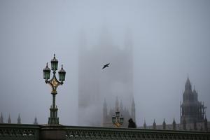 Fog settles over the Houses of Parliament on Dec. 28 in London, shortly after the UK government nixed a plan to allow household mixing in England for five days over Christmas. Fog settles over the Houses of Parliament on Dec. 28 in London, shortly after the UK government nixed a plan to allow household mixing in England for five days over Christmas.