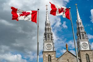 Canadian flags in the forefront of the Notre-Dame Cathedral Basilica in Ottawa. Canada Canadian flags in the forefront of the Notre-Dame Cathedral Basilica in Ottawa. Canada