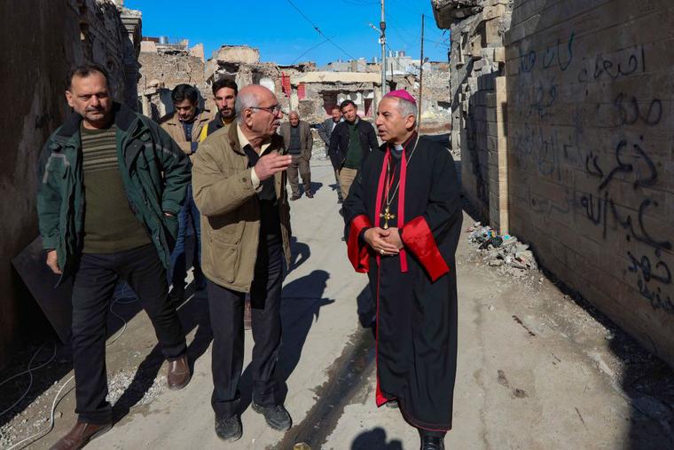 The Chaldean Catholic Archbishop of Mosul Najeeb Michaeer (R) tours the old part of the northern city of Mosul, to follow the progress of restoration works there, on February 3, 2021. From Mosul's rubble-strewn streets to ancient churches at Karamlesh badly damaged by the Islamic State group, Archbishop Najeeb Michaeel is preparing for the first-ever papal visit to Iraq. The Chaldean Catholic Archbishop of Mosul Najeeb Michaeer (R) tours the old part of the northern city of Mosul, to follow the progress of restoration works there, on February 3, 2021. From Mosul's rubble-strewn streets to ancient churches at Karamlesh badly damaged by the Islamic State group, Archbishop Najeeb Michaeel is preparing for the first-ever papal visit to Iraq.