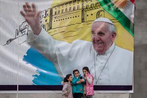 Young girls take a selfie in front of a poster promoting the upcoming trip of Pope Francis on March 4, 2021 in Erbil, Iraq. On March 5, Pope Francis will start the historic first ever papal visit to Iraq. In his first foreign trip since the start of the pandemic Pope Francis will visit Baghdad, Najaf, Erbil and the cities of Qaraqosh and Mosul, which were heavily destroyed by ISIS. Young girls take a selfie in front of a poster promoting the upcoming trip of Pope Francis on March 4, 2021 in Erbil, Iraq. On March 5, Pope Francis will start the historic first ever papal visit to Iraq. In his first foreign trip since the start of the pandemic Pope Francis will visit Baghdad, Najaf, Erbil and the cities of Qaraqosh and Mosul, which were heavily destroyed by ISIS.
