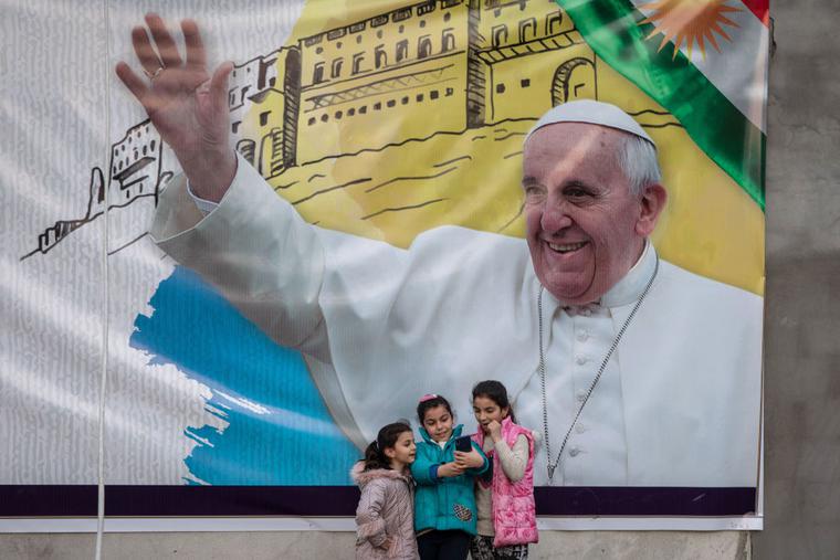 Young girls take a selfie in front of a poster promoting the upcoming trip of Pope Francis on March 4, 2021 in Erbil, Iraq. On March 5, Pope Francis will start the historic first ever papal visit to Iraq. In his first foreign trip since the start of the pandemic Pope Francis will visit Baghdad, Najaf, Erbil and the cities of Qaraqosh and Mosul, which were heavily destroyed by ISIS. Young girls take a selfie in front of a poster promoting the upcoming trip of Pope Francis on March 4, 2021 in Erbil, Iraq. On March 5, Pope Francis will start the historic first ever papal visit to Iraq. In his first foreign trip since the start of the pandemic Pope Francis will visit Baghdad, Najaf, Erbil and the cities of Qaraqosh and Mosul, which were heavily destroyed by ISIS.