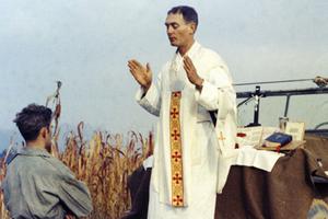 Father Emil Kapaun celebrates Mass using the hood of a Jeep as his altar on Oct. 7, 1950. Father Emil Kapaun celebrates Mass using the hood of a Jeep as his altar on Oct. 7, 1950.