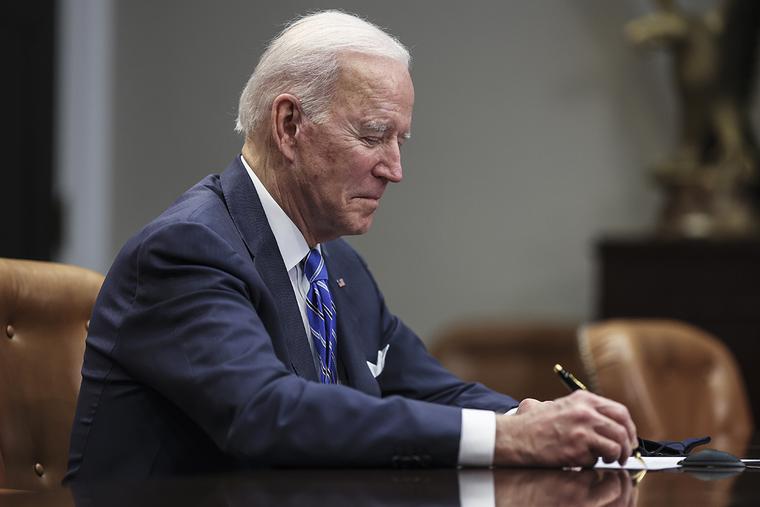 President Joe Biden takes notes during a virtual call in the Roosevelt Room of the White House on Thursday President Joe Biden takes notes during a virtual call in the Roosevelt Room of the White House on Thursday