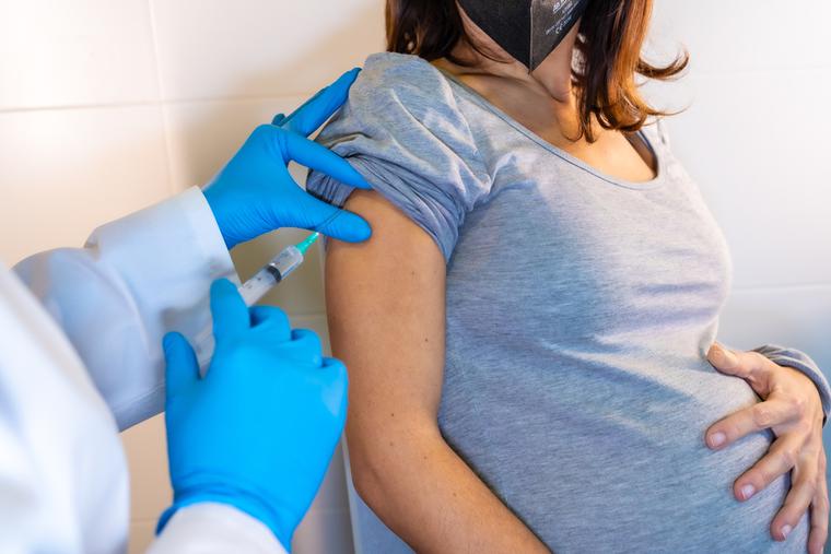 A pregnant mother receives the COVID-19 vaccine shot. A pregnant mother receives the COVID-19 vaccine shot.