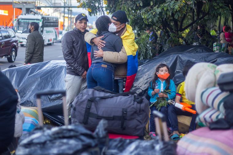 Several immigrants from Venezuela with suitcases on the street waiting to return to their country. Several immigrants from Venezuela with suitcases on the street waiting to return to their country.