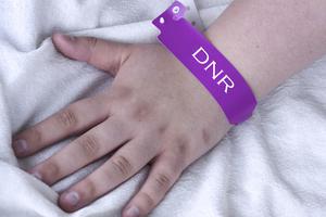 A female patient wearing a DNR bracelet at the hospital. A female patient wearing a DNR bracelet at the hospital.