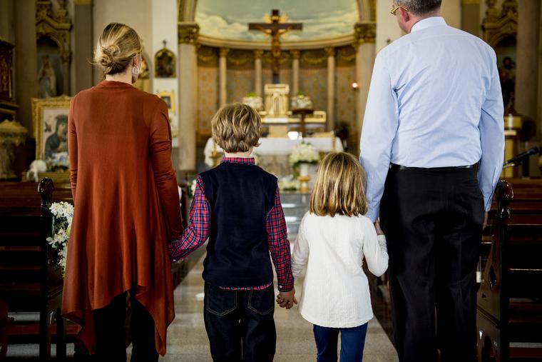 A family attends Sunday Mass. A family attends Sunday Mass.
