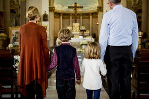 A family attends Sunday Mass. A family attends Sunday Mass.