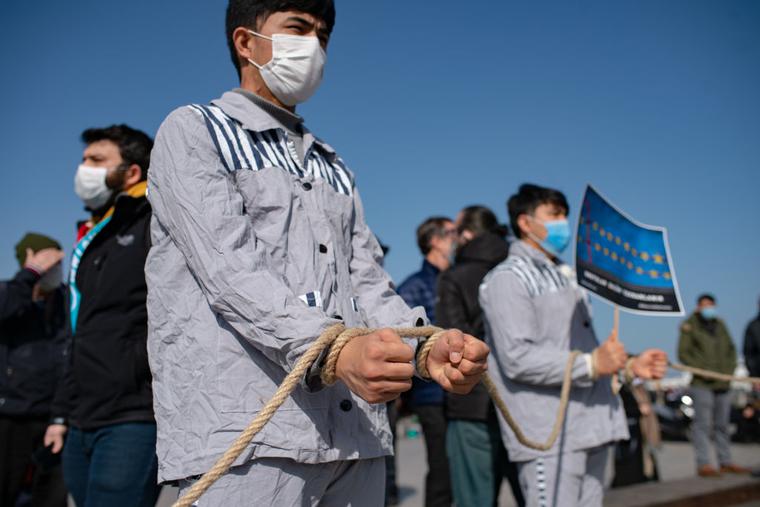 Members of the Muslim Uyghur minority keep symbolically their hands tied with a rope as they demonstrate to ask for news of their relatives at Uskudar square in Istanbul on February 26, 2021. Members of the Muslim Uyghur minority keep symbolically their hands tied with a rope as they demonstrate to ask for news of their relatives at Uskudar square in Istanbul on February 26, 2021.