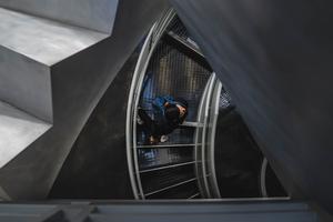 A student walks down a spiral staircase on way to class. A student walks down a spiral staircase on way to class.