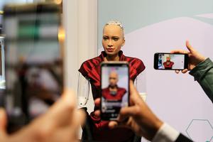 Attendees take smartphone photographs of Hanson Robotics Inc.'s humanoid robot "Sophia" on the opening day of the MWC Barcelona in Barcelona, Spain, on Feb. 25, 2019. Attendees take smartphone photographs of Hanson Robotics Inc.'s humanoid robot "Sophia" on the opening day of the MWC Barcelona in Barcelona, Spain, on Feb. 25, 2019.