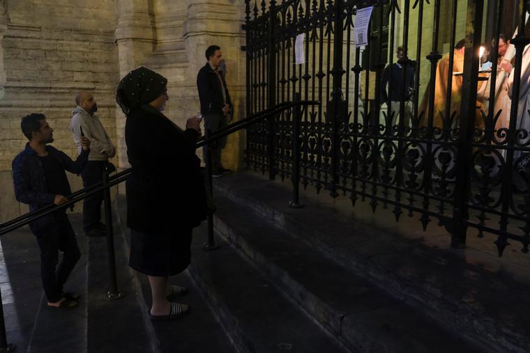 People take part in Easter vigil mass behind closed doors in Catholic church of Sainte-Catherine in Brussels, Belgium, on Holy Saturday, April 11, 2020. People take part in Easter vigil mass behind closed doors in Catholic church of Sainte-Catherine in Brussels, Belgium, on Holy Saturday, April 11, 2020.