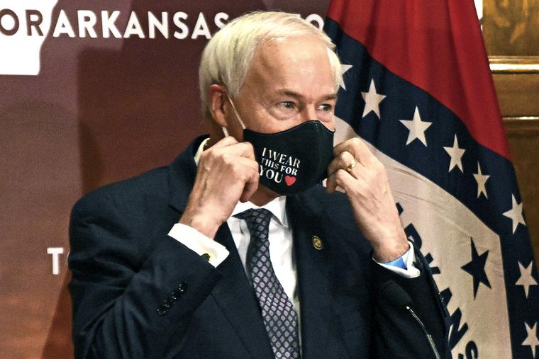 Arkansas Gov. Asa Hutchinson removes his mask before a briefing at the state capitol in Little Rock on July 20, 2020. Arkansas Gov. Asa Hutchinson removes his mask before a briefing at the state capitol in Little Rock on July 20, 2020.