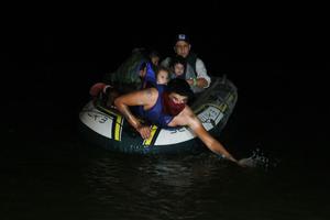 A smuggler paddles ashore a group of migrants entering the U.S. on the Rio Grande on March 30, 2021 in Roma, Texas. The group made up of individuals from Central America turned themselves into the U.S. Border Patrol after crossing as they seek asylum in the United States. A smuggler paddles ashore a group of migrants entering the U.S. on the Rio Grande on March 30, 2021 in Roma, Texas. The group made up of individuals from Central America turned themselves into the U.S. Border Patrol after crossing as they seek asylum in the United States.