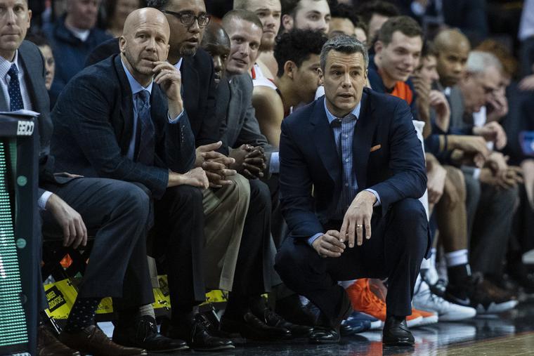 Virginia Cavaliers Assistant Coach Brad Soderberg (l) and Head Coach Tony Bennett (c) look on from the bench during the first half of the game between the Pittsburgh Panthers and the Virginia Cavaliers on March 2, 2019, at John Paul Jones Arena in Charlottesville, Virginia. The Cavs went on to win the 2019 NCAA National Championship. Virginia Cavaliers Assistant Coach Brad Soderberg (l) and Head Coach Tony Bennett (c) look on from the bench during the first half of the game between the Pittsburgh Panthers and the Virginia Cavaliers on March 2, 2019, at John Paul Jones Arena in Charlottesville, Virginia. The Cavs went on to win the 2019 NCAA National Championship.