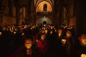 Chinese Catholics hold candles during the Easter Vigil Mass at a church in Beijing on April 3. Chinese Catholics hold candles during the Easter Vigil Mass at a church in Beijing on April 3.