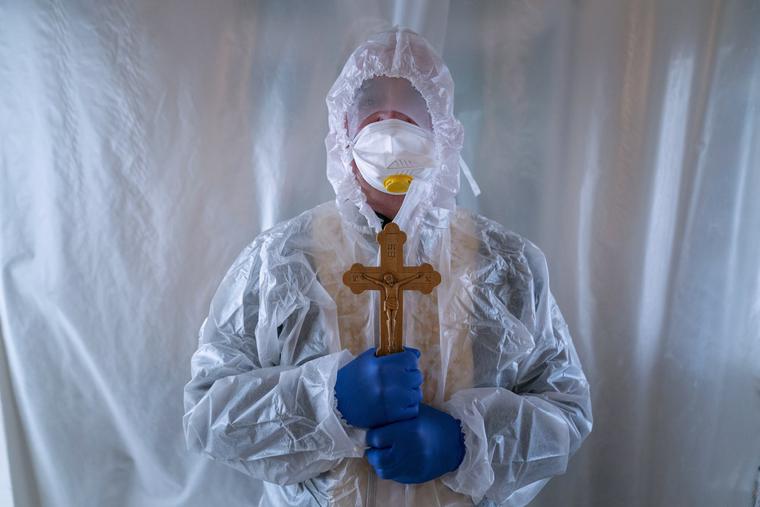 Father Stephan, a Ukrainian Greek Catholic Church priest, wearing a special suit to protect himself against coronavirus, stands, after visiting patients with COVID-19 at an intensive care unit of the emergency hospital in Lviv, Western Ukraine, Saturday, Jan. 9, 2021. Father Stephan, a Ukrainian Greek Catholic Church priest, wearing a special suit to protect himself against coronavirus, stands, after visiting patients with COVID-19 at an intensive care unit of the emergency hospital in Lviv, Western Ukraine, Saturday, Jan. 9, 2021.