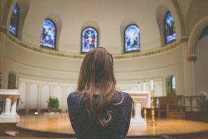A young parishioner prays inside St. Thomas Catholic Church in Ann Arbor, Michigan. A young parishioner prays inside St. Thomas Catholic Church in Ann Arbor, Michigan.