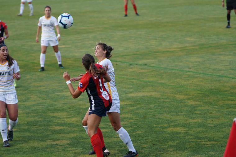 High school girls play a soccer game. High school girls play a soccer game.