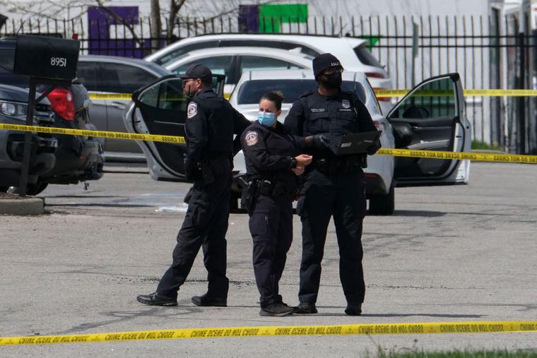 Police officers stand guard outside the site of a mass shooting at a FedEx facility in Indianapolis, Indiana on April 16, 2021. Police officers stand guard outside the site of a mass shooting at a FedEx facility in Indianapolis, Indiana on April 16, 2021.