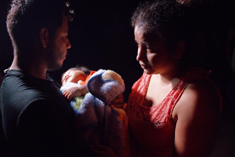 Honduran parents hold their sleeping boy after crossing the Rio Grande from Mexico on April 15, 2021 in Roma, Texas. Honduran parents hold their sleeping boy after crossing the Rio Grande from Mexico on April 15, 2021 in Roma, Texas.
