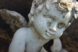 A statue of an angel marking the grave of a baby. A statue of an angel marking the grave of a baby.