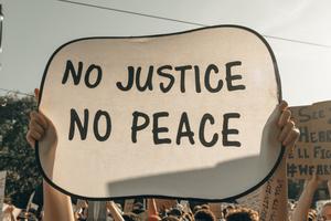 Protesters in Minneapolis hold signs before the verdict in the case against Derek Chauvin was decided. Protesters in Minneapolis hold signs before the verdict in the case against Derek Chauvin was decided.