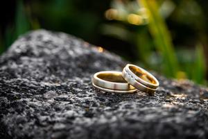 A photographer captures a couple's wedding rings on the day of marriage. A photographer captures a couple's wedding rings on the day of marriage.
