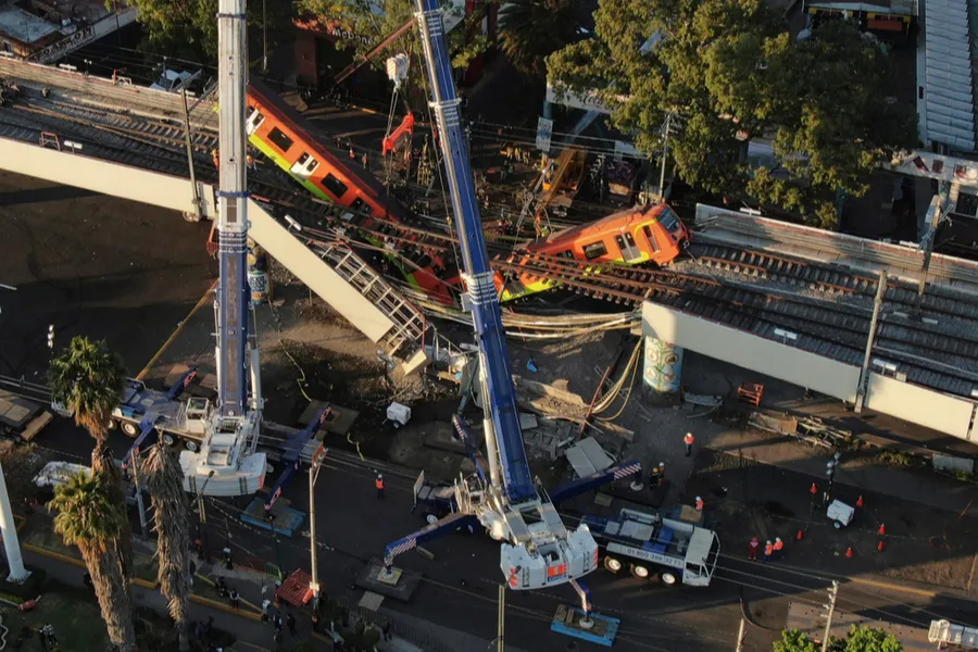 Construction crews attend to the collapsed cars of the elevated metro line in Mexico City, May 4, 2021. Construction crews attend to the collapsed cars of the elevated metro line in Mexico City, May 4, 2021.