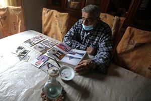 Jean Assaf, an 80-year-old retired police officer who earns a monthly pension worth around $180, down from $1,400 before the crisis, looks at an old photo album at his home in Beirut’s Mar Mikhael district on March 24. Lebanon is in the grips of its worst economic crisis since the 1975-1990 civil war, with more than half of its population living in poverty. Jean Assaf, an 80-year-old retired police officer who earns a monthly pension worth around $180, down from $1,400 before the crisis, looks at an old photo album at his home in Beirut’s Mar Mikhael district on March 24. Lebanon is in the grips of its worst economic crisis since the 1975-1990 civil war, with more than half of its population living in poverty.
