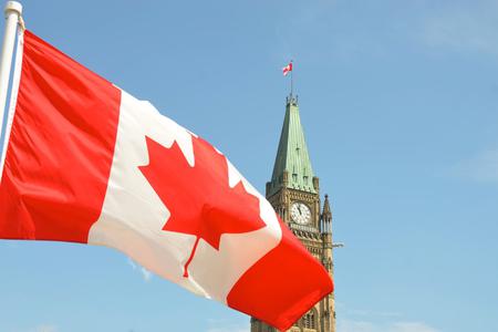 Canadian flag waving in front of the Parliament Building on Parliament Hill in Ottawa. Canadian flag waving in front of the Parliament Building on Parliament Hill in Ottawa.