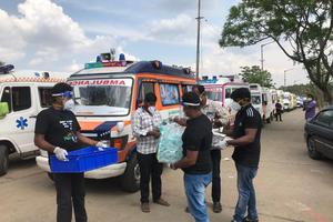 Ambulance drivers being given food packets from 'Mother's Kitchen.' Ambulance drivers being given food packets from 'Mother's Kitchen.'