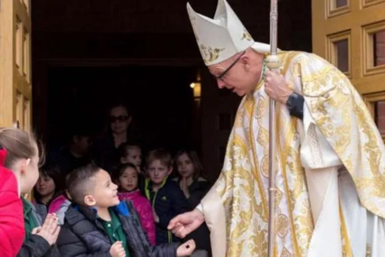 Bishop James Wall of Gallup, New Mexico, greets young parishioners following Mass at Sacred Heart Cathedral. Bishop James Wall of Gallup, New Mexico, greets young parishioners following Mass at Sacred Heart Cathedral.